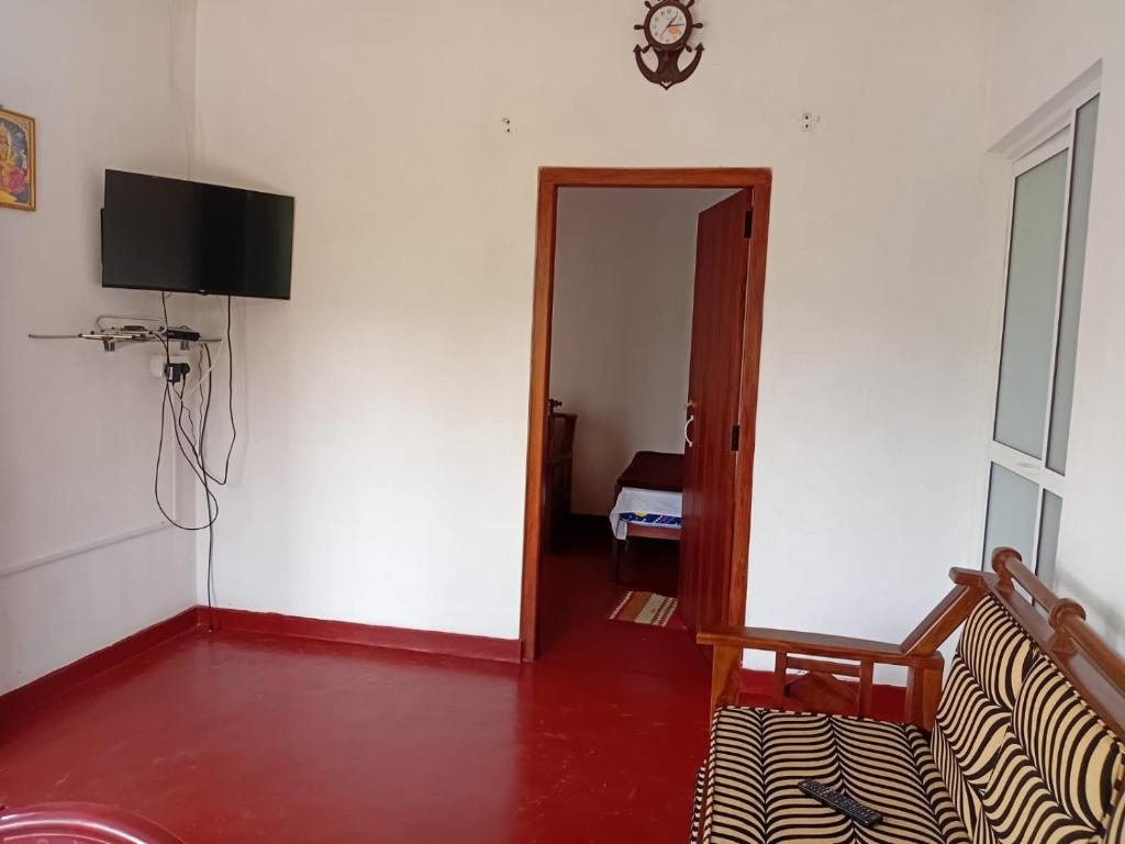 a room with a couch and a television on a wall at Browns Hill Villa - Ella in Ella