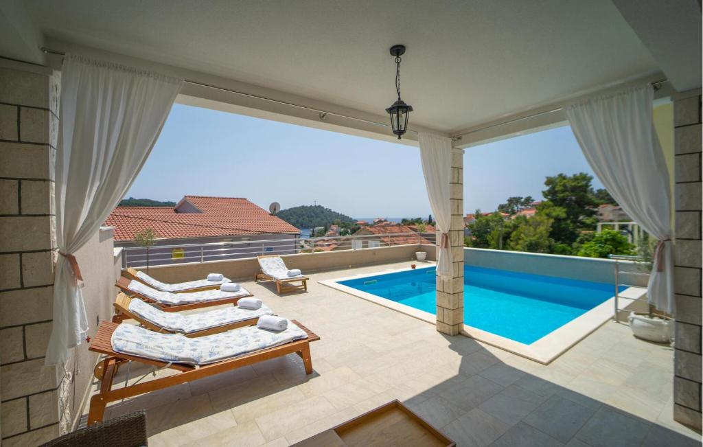 a balcony with a view of a swimming pool at Holiday Home Brna V in Brna