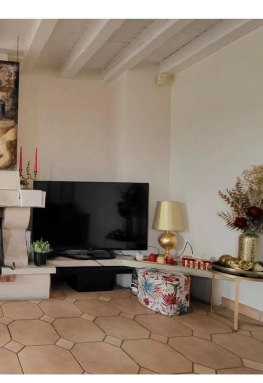 a living room with a large screen tv and a table at La Villa des Amis 10 couchages au clos de la piscine in Montgeron
