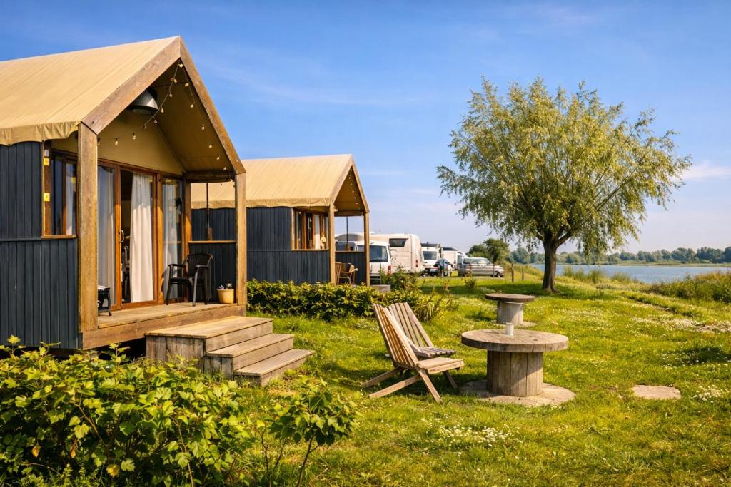 a tiny house with a bench and a bird bath at Luxury Suite in Heerewaarden