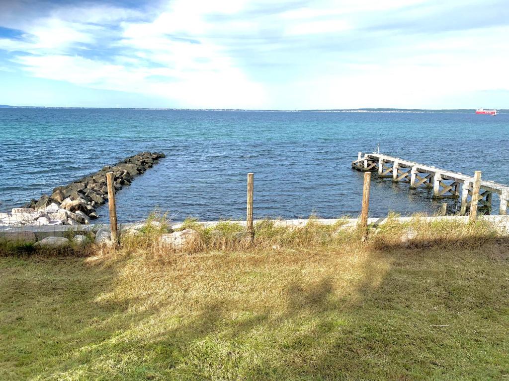 a dock in the middle of a body of water at Gruse 9 Svaneke in Svaneke