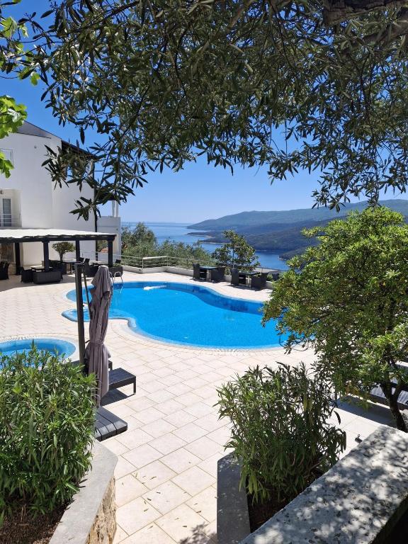 a swimming pool with a view of the water at Hotel Villa Annette in Rabac