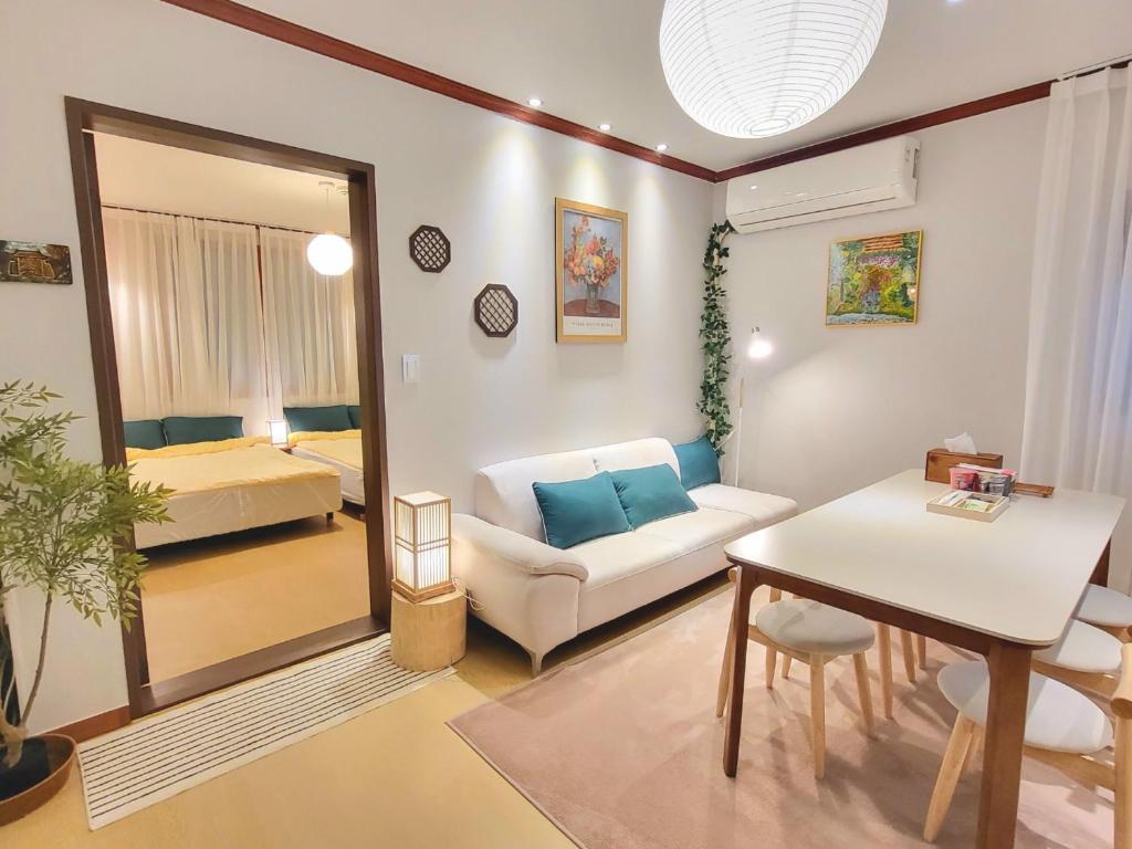 a living room with a couch and a table at 대구 K Stay in Daegu