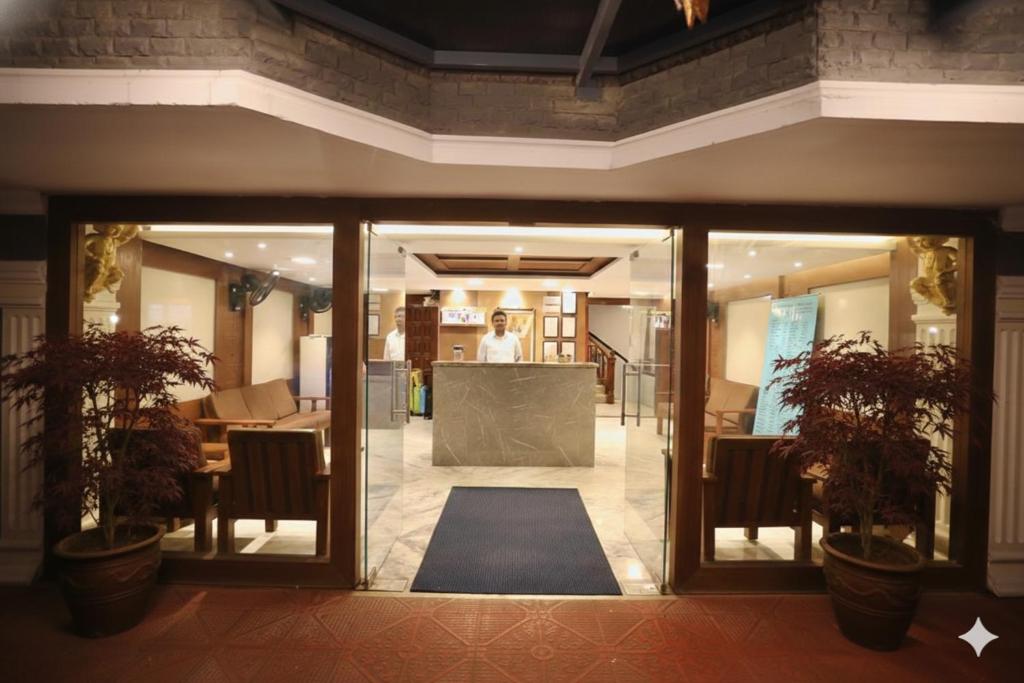 a lobby with a person standing in the background at AR Residency Tnagar Chennai in Chennai