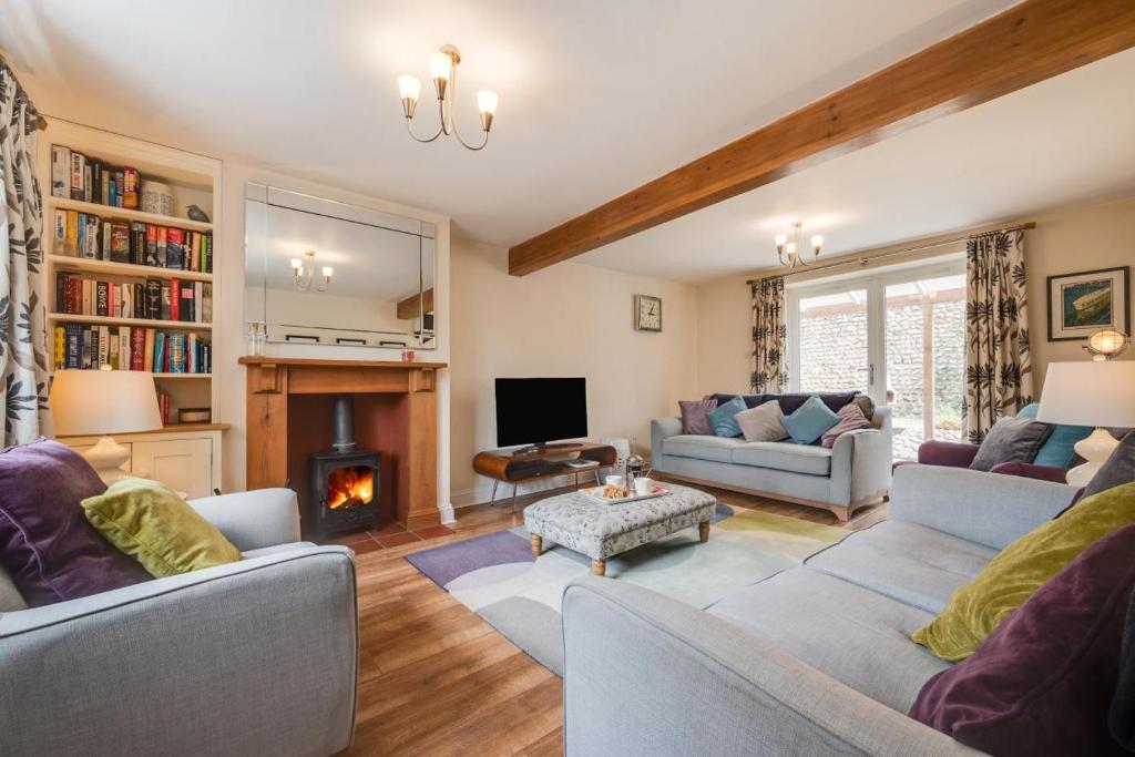a living room with two couches and a fireplace at 3 Bed in Bodham oc-1638 in Bodham