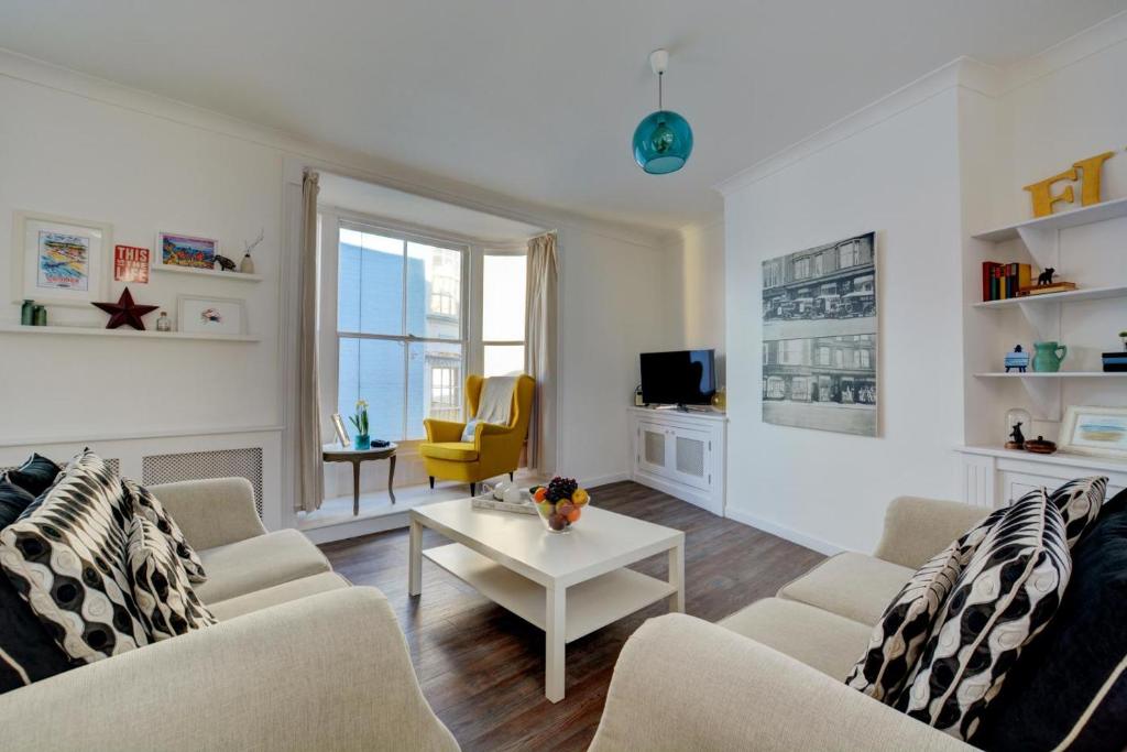 a living room with two couches and a table at 3 Bed in Cromer oc-1727 in Cromer