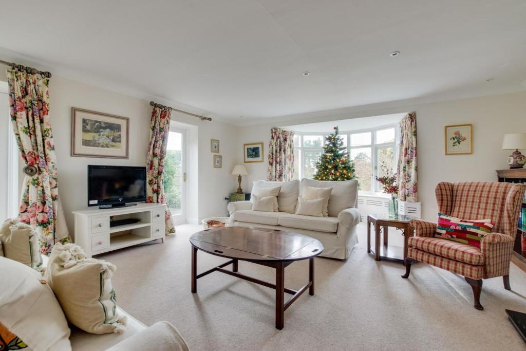 a living room filled with furniture and a christmas tree at 3 Bed in Cley oc-2122 in Cley next the Sea