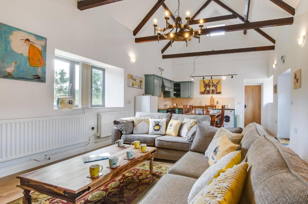 a living room with a couch and a table at 3 Bed in Shereford oc-2173 in Tatterford