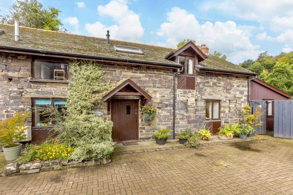 an old stone house with plants in front of it at 2 Bed in Swimbridge oc-n0209 in Swimbridge
