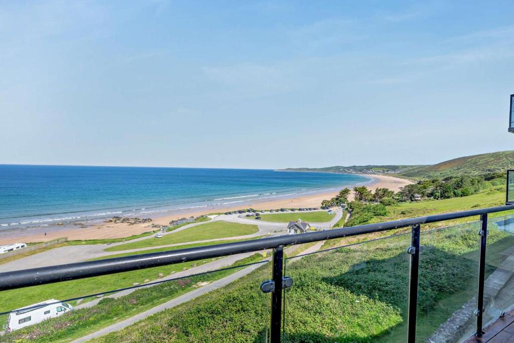 a view of the beach from the balcony of a house at 2 Bed in Putsborough oc-f27451 in Croyde