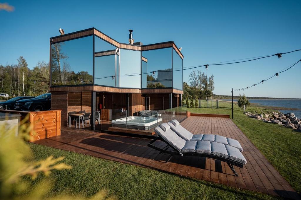 a glass house on a deck with two lounge chairs at Luxury Resort Reiu in Reiu