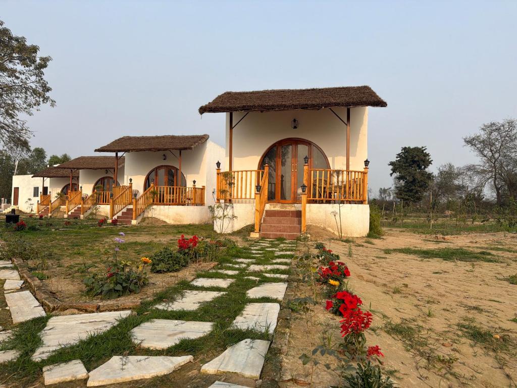 a small house with a pathway leading to it at The Tarai Pilibhit in Kālīnagar