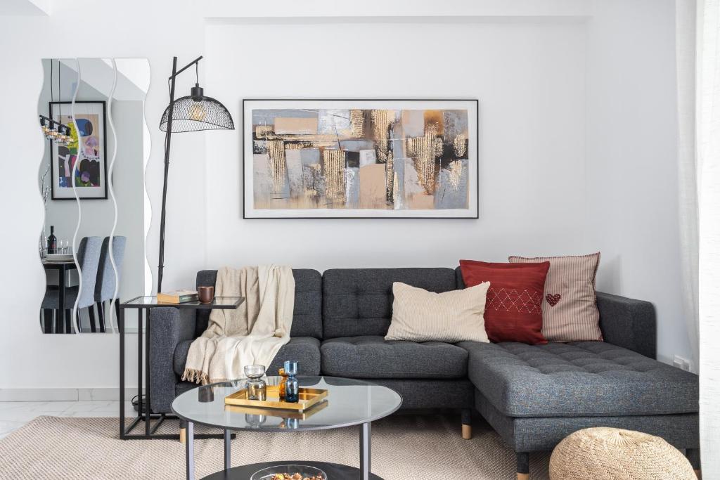 a living room with a couch and a table at Hinoki 2-Bedroom Apartment in Larnaca