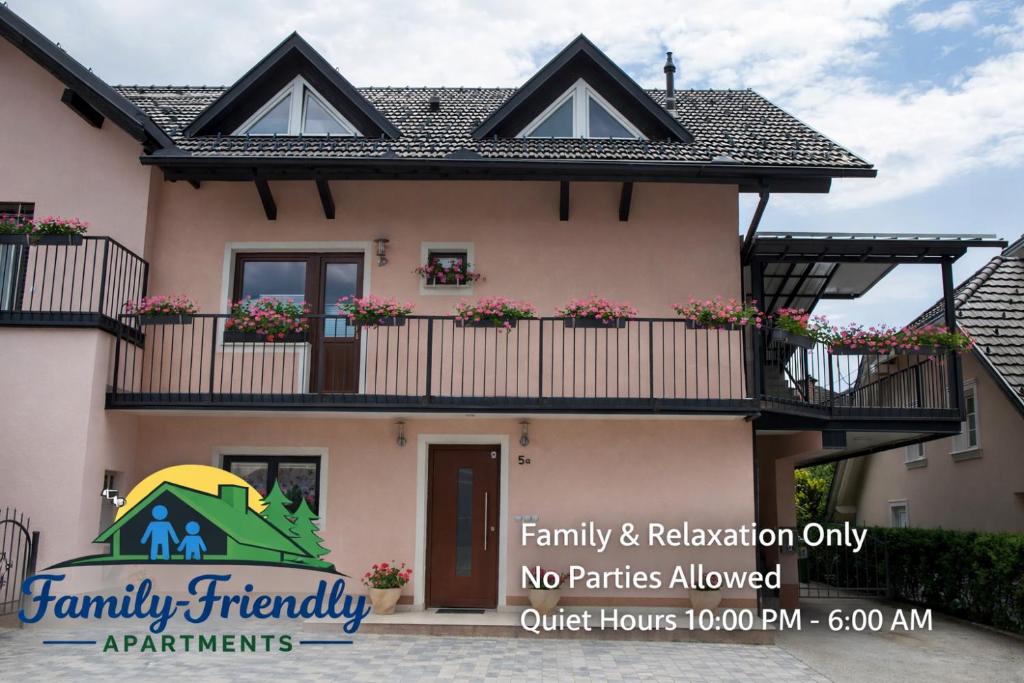 a house with flowers on the balconies at Luxury apartment Karolina in Bled