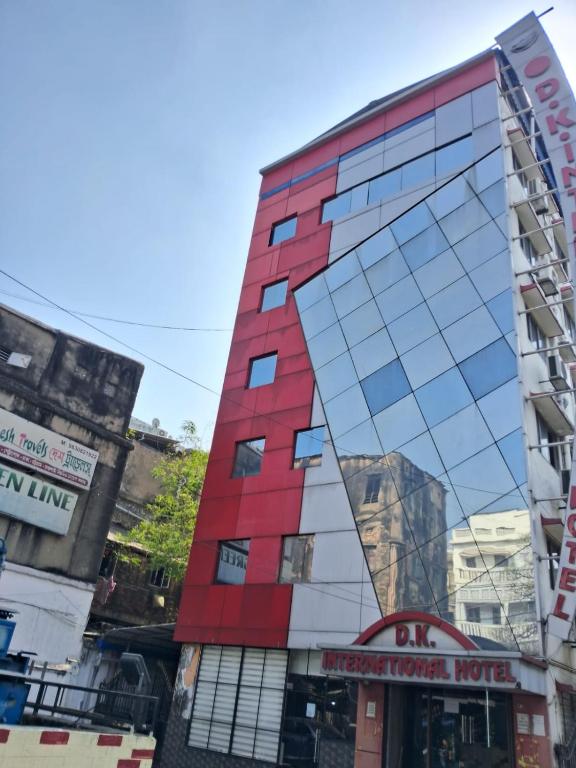 a tall red building with a mirror facade at D. K. INTERNATIONAL HOTEL PVT. LTD in Calcutta Bara Bazar