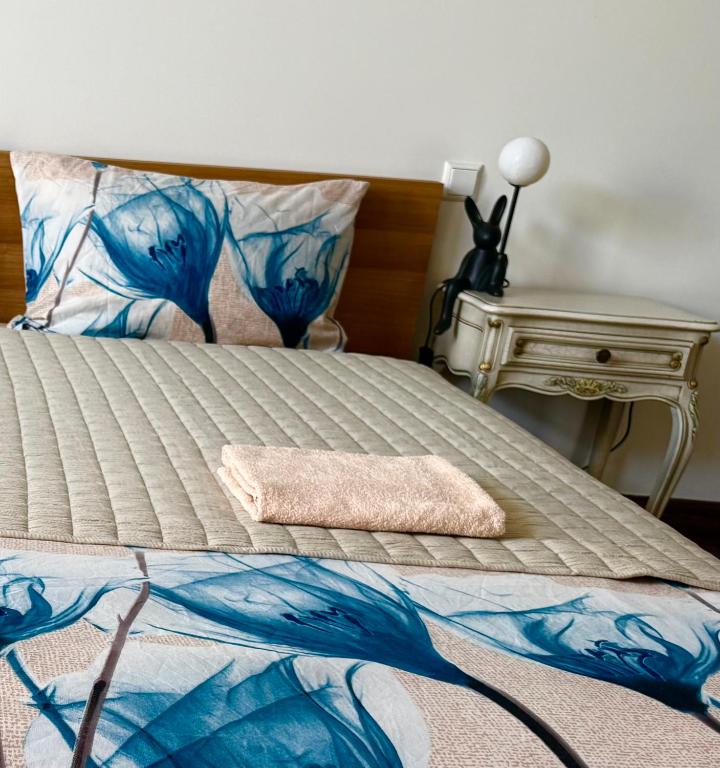 a bed with a towel on top of it at CENTRO House in Alytus