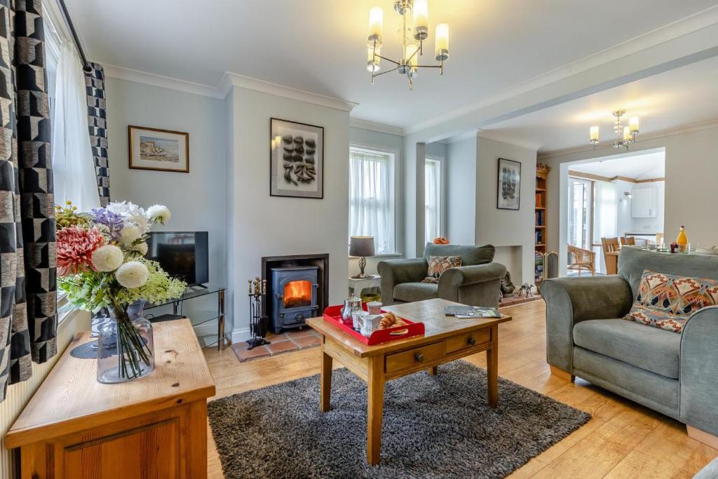 a living room with a couch and a fireplace at 2 Bed in Mundesley oc-1353 in Mundesley