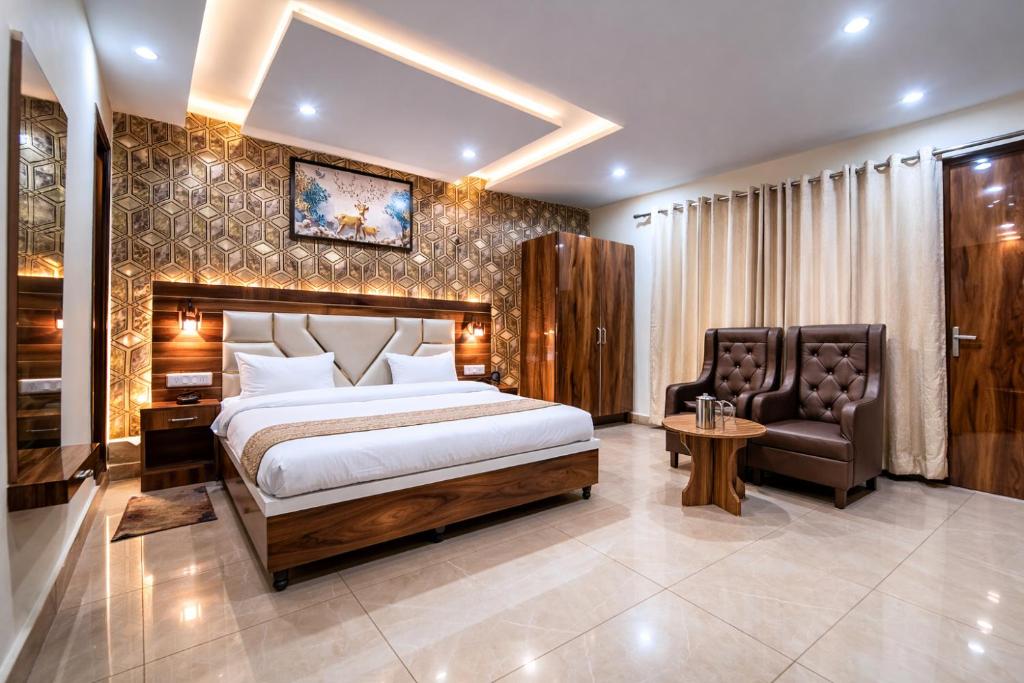 a bedroom with a king sized bed and a chair at M S Resort Dalhousie, Near mall road Gandhi Chowk Dalhousie in Dalhousie