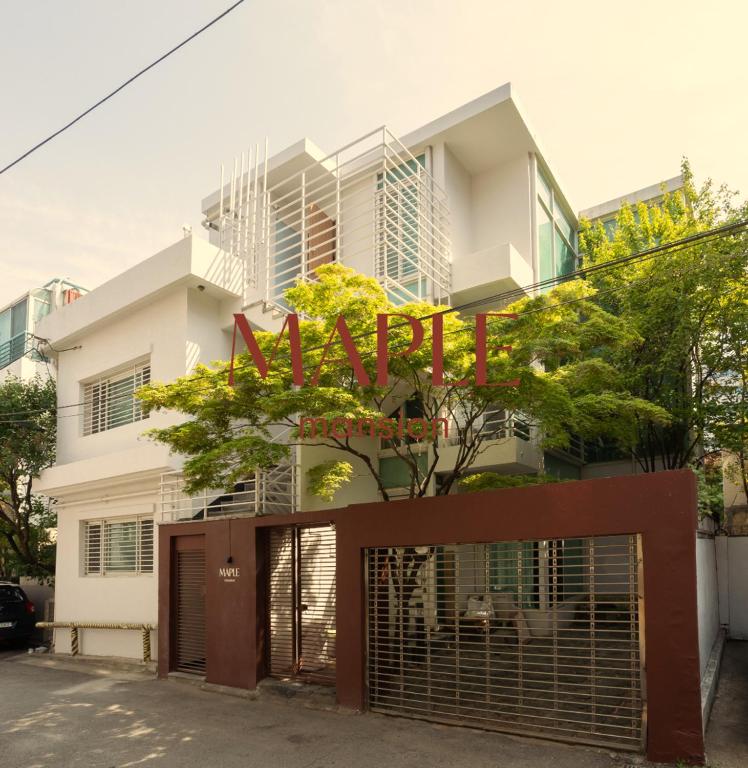 a white building with a sign that reads mail at MAPLE MANSION Hongdae in Seoul