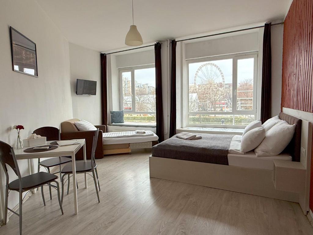 a bedroom with a bed and a table and a chair at ZOOM Apartments - Budapest in Budapest