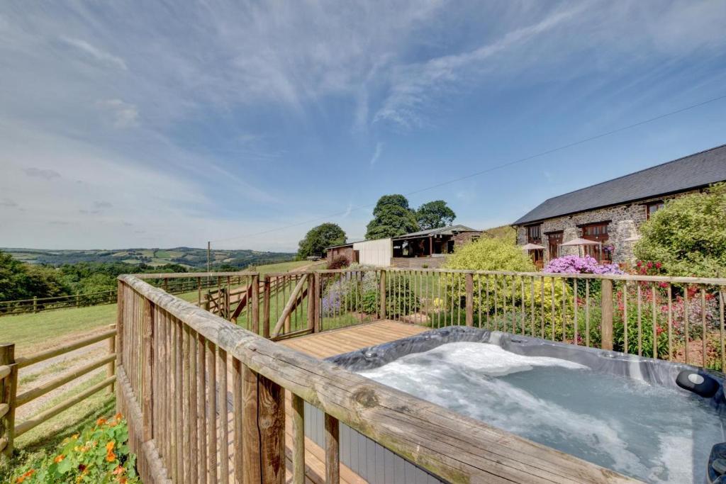 a hot tub on the deck of a house at 3 Bed in Tiverton oc-thresh in Bampton