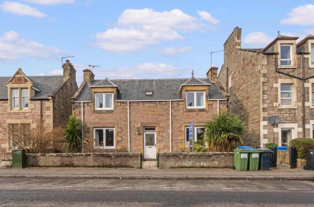 an old brick house on the corner of a street at mySTAYINN Strathblane House in Inverness