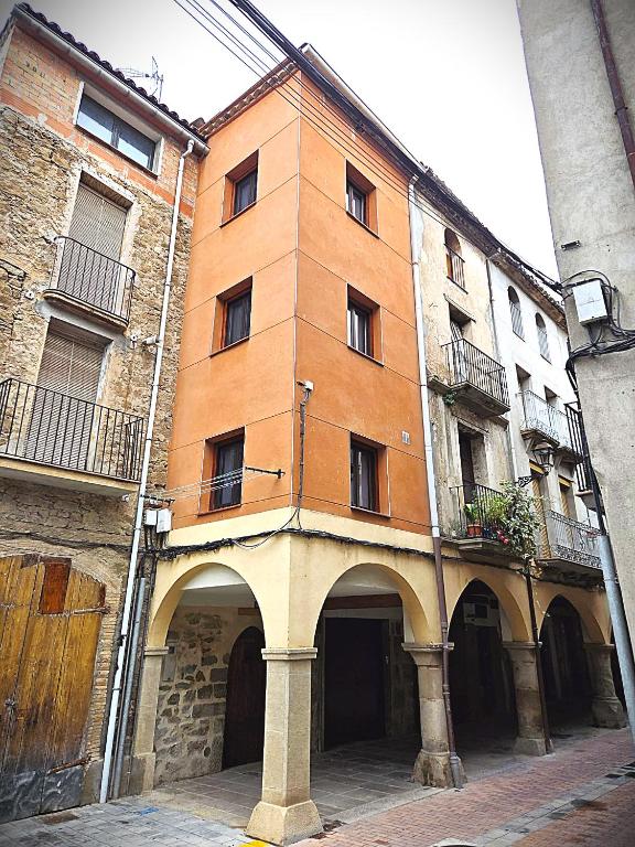 a large brick building with an archway in a street at CAL MA Ponts in Ponst