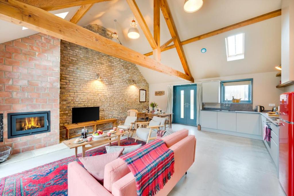 a living room with a fireplace and a brick wall at 2 Bed in Holme-on-Spalding-Moor oc-vy215 in Holme upon Spalding Moor