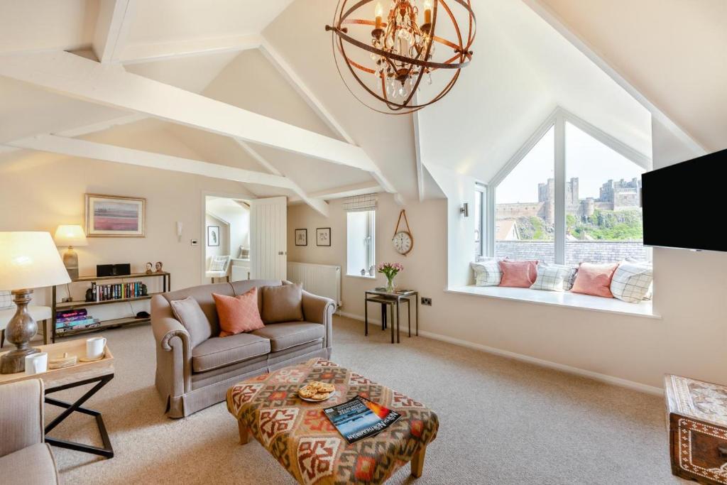 a living room with a couch and a table at 2 Bed in Bamburgh oc-gd1165 in Bamburgh