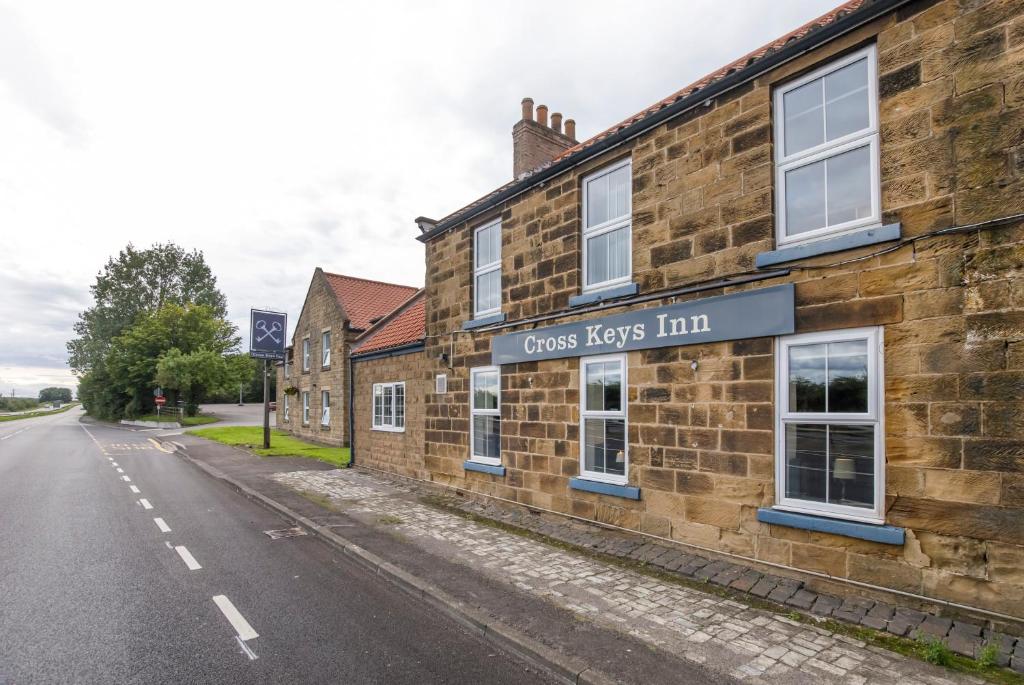 an old brick building on the side of a street at Cross Keys by Chef & Brewer Collection in Nunthorpe