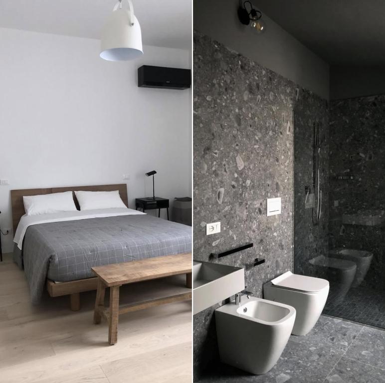 a bedroom with a bed and a toilet and a sink at whiterooms in Cesena