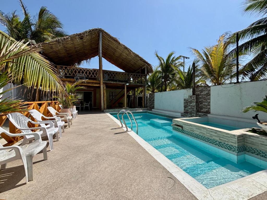 a swimming pool with lounge chairs and a resort at Paradise BH in Maizal