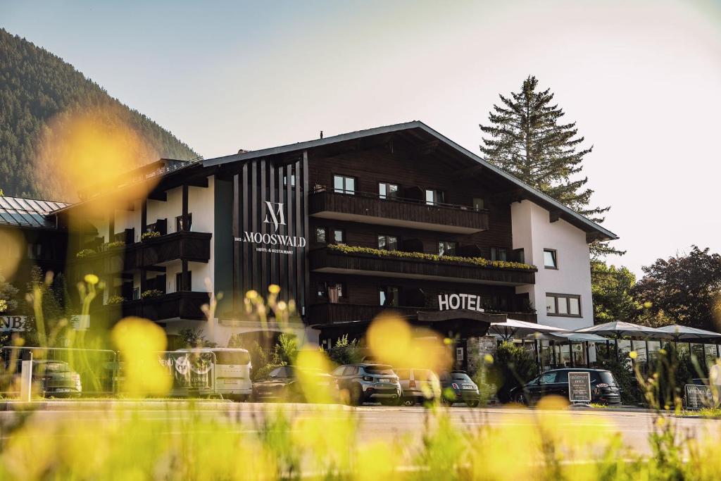a hotel with cars parked in front of it at das MOOSWALD in Obsteig