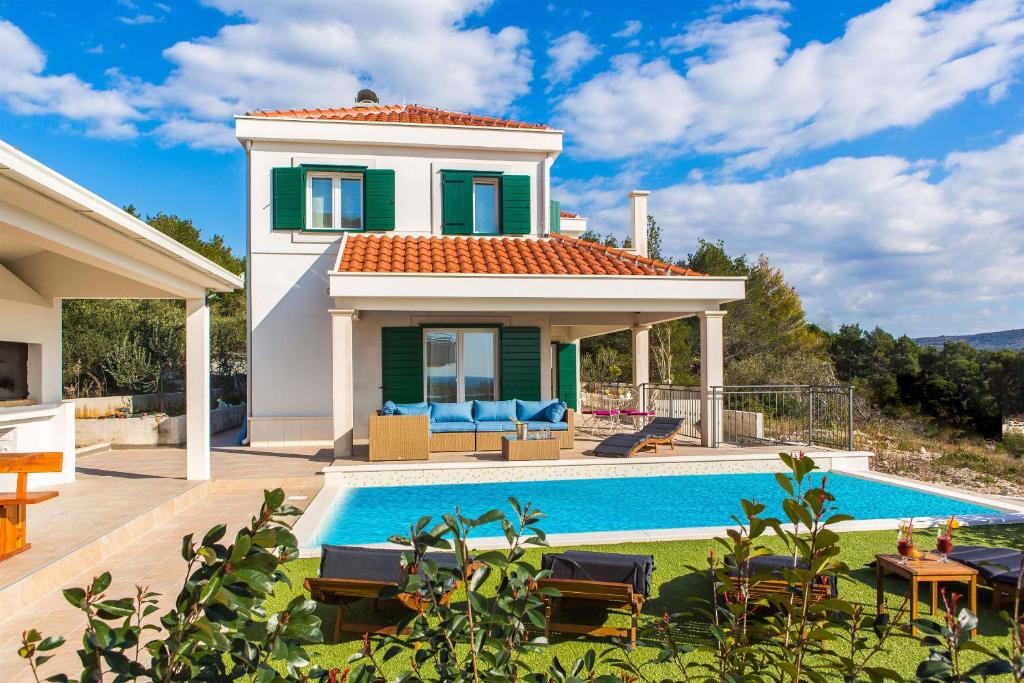 a villa with a swimming pool and a house at Villa Eni in Primošten