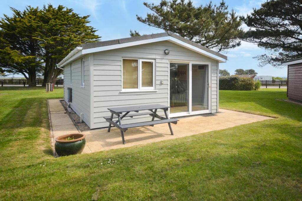a small shed with a picnic table in a yard at 2 Bed in Padstow oc-p00551 in Saint Merryn