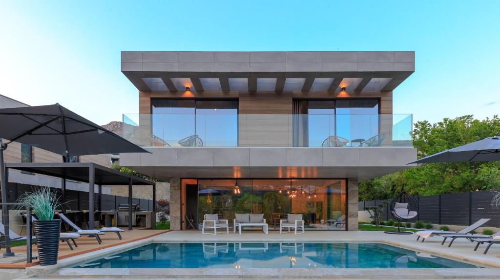 a house with a swimming pool in front of it at Villa Lorkia in Baška