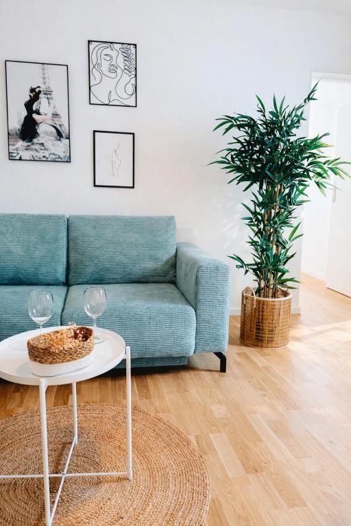 a living room with a couch and a table at Suites in Mödling in Mödling