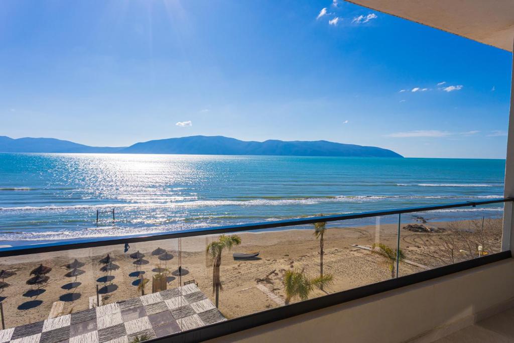 a view of the beach from the balcony of a condo at IDeal Sea View Apartment in Vlorë