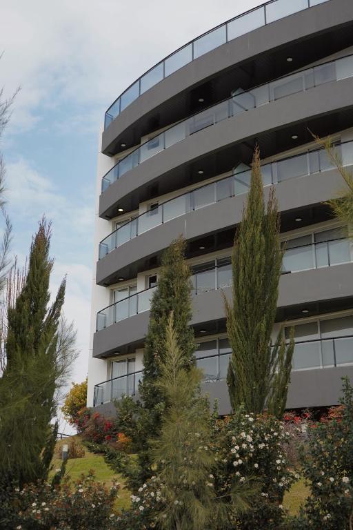 an office building with trees in front of it at Veneto Village - Vista al Lago - 10 minutos a Carlos Paz in Villa Parque Siquiman
