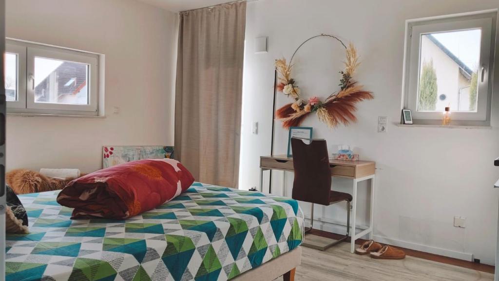 a bedroom with a bed and a desk and a table at Studioraum nähe Koblenz in Sankt Sebastian