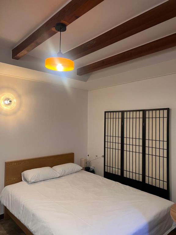 a bedroom with a large white bed and a light at Stay Us 3151 in Seongnam