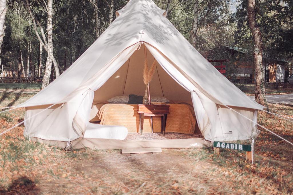 a tent with a bed and a table in it at Le Spot Passy in Passy
