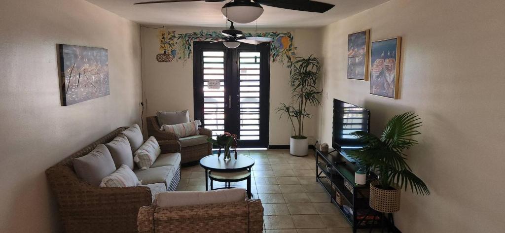 a living room with couches and a ceiling fan at Beach vibes condo in Luquillo in Luquillo
