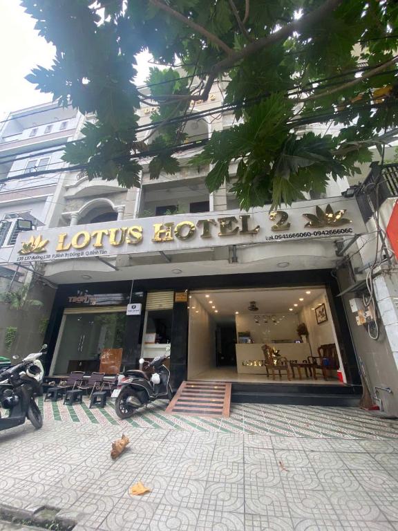 a store with motorcycles parked outside of a building at LotusHotel 2 in Ho Chi Minh City