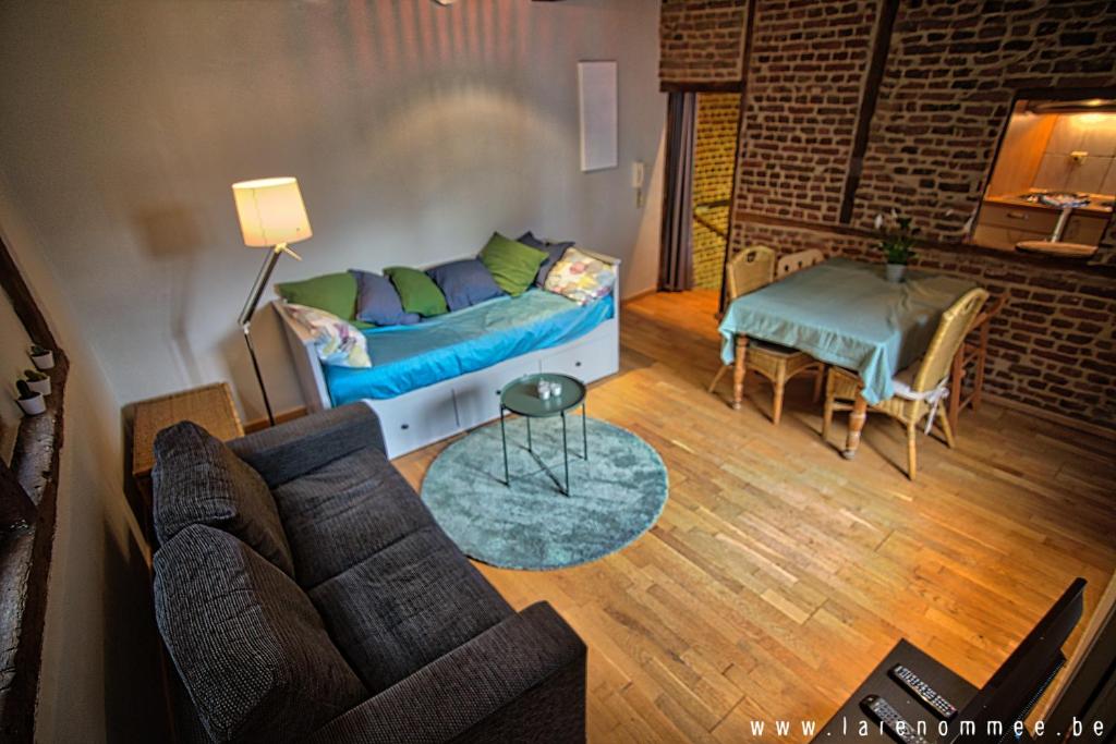 a living room with a couch and a table at Maison de charme dans quartier historique in Liège