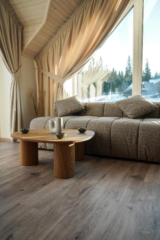 a living room with a couch and a coffee table at Апартаменти Rest Hill in Vorokhta