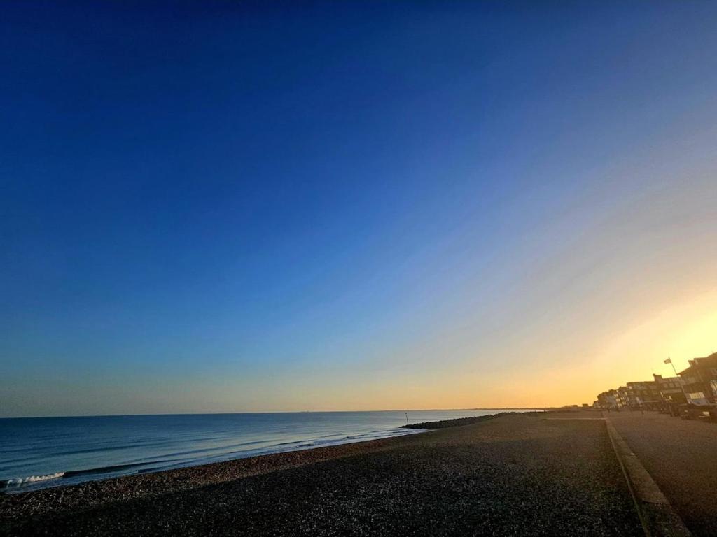 a view of the beach at sunset at Enbrook View in Sandgate