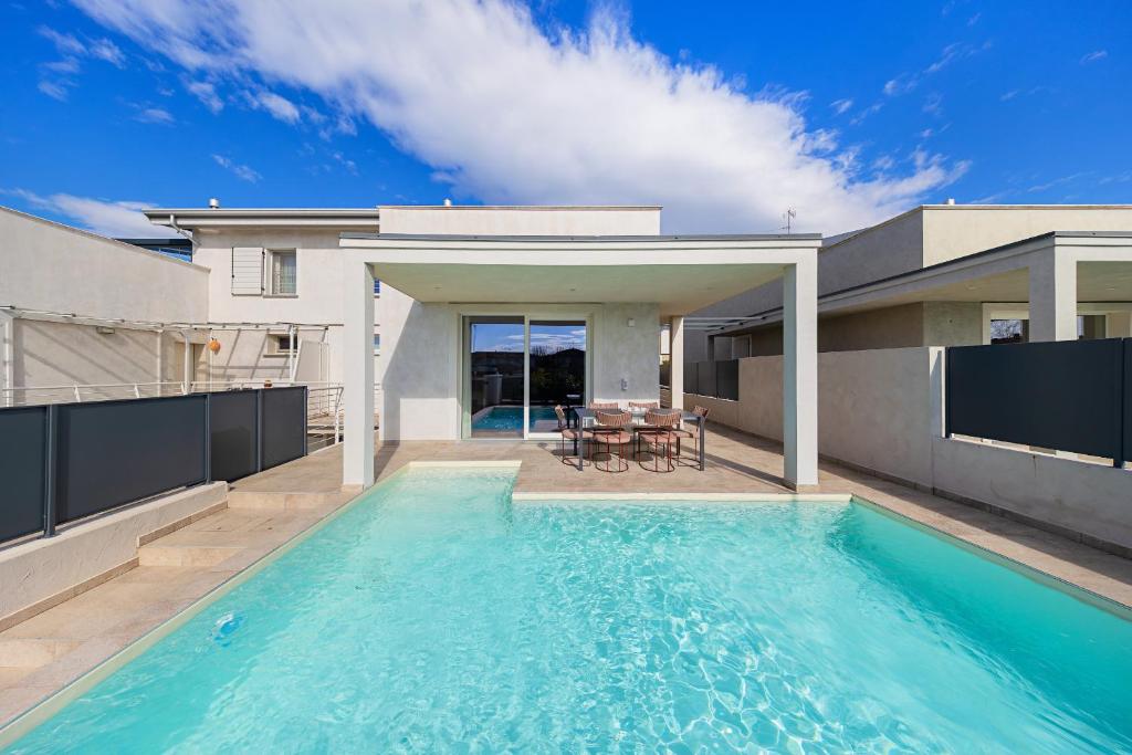 a swimming pool in the backyard of a house at Luxury Villa Prestige in Sirmione