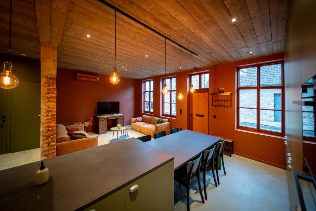 a living room with a large table and chairs at In De Rooden Hoed in Poperinge