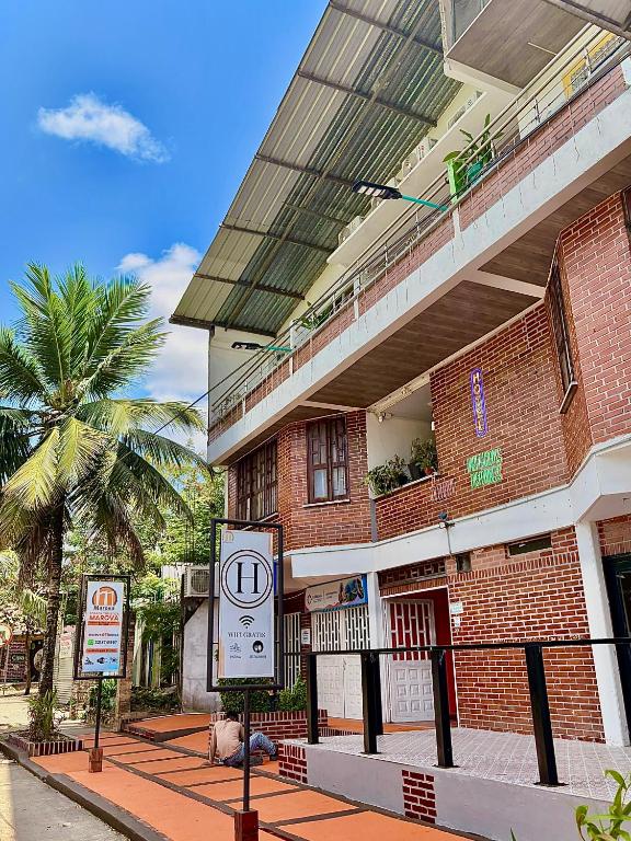 a building with a sign in front of it at Posada Turística Marova in Puerto Inírida